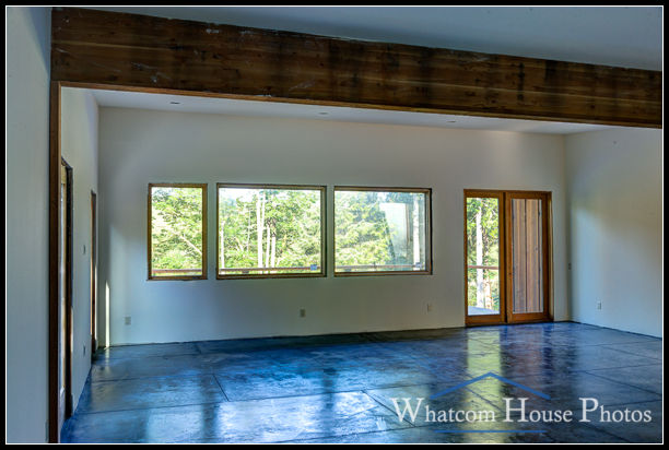 Unfinished great room interior with concrete floor